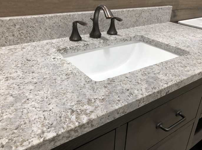  |  bathroom granite counter over wooden vanity cabinet and white rectangular sink with chrome faucet